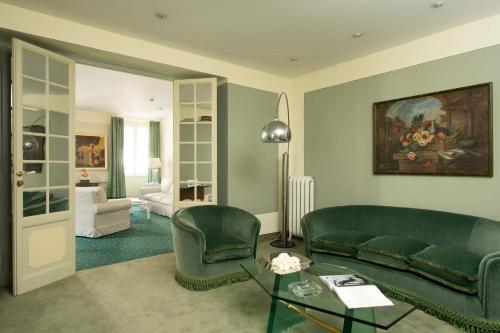 a living room with a couch and chairs and a table at Hotel Gregoriana in Rome