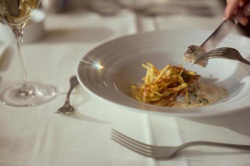 a plate of food on a table with a fork at Hotel Sonnalp in Kirchberg in Tirol