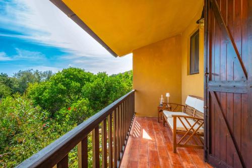 a balcony of a house with a wooden door at SAILOR'S House STINTINO in Stintino