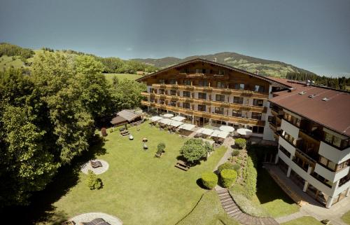 an aerial view of a hotel with a large yard at Hotel Sonnalp in Kirchberg in Tirol