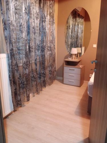 a bathroom with a mirror and a dresser and a sink at Polixniati's House in Polichnítos
