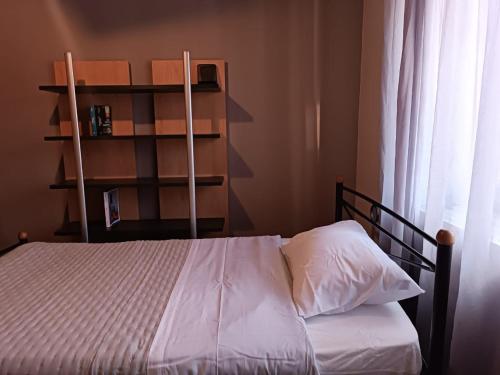 a bedroom with a bed and a book shelf at Polixniati's House in Polichnítos