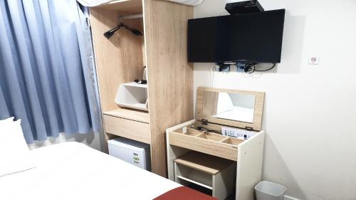 a bedroom with a bed and a tv on a wall at MAYONE HOTEL Myeongdong in Seoul