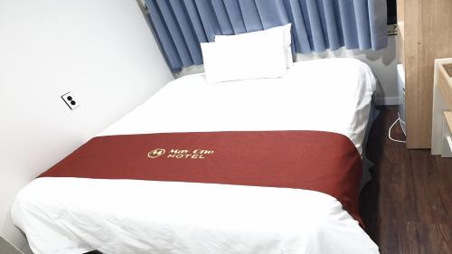 two beds in a small room with a sign that says just five noise at MAYONE HOTEL Myeongdong in Seoul