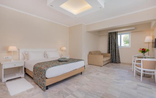 a hotel room with a bed and a desk at Zante Park Resort & Spa BW Premier Collection in Laganas