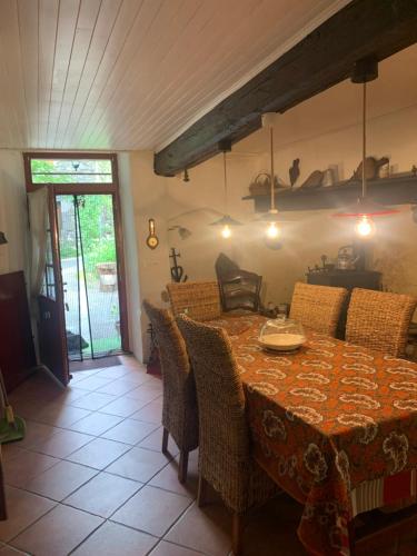 a dining room with a table with chairs and a tableablish at Grande maison cévenole authentique in Valleraugue
