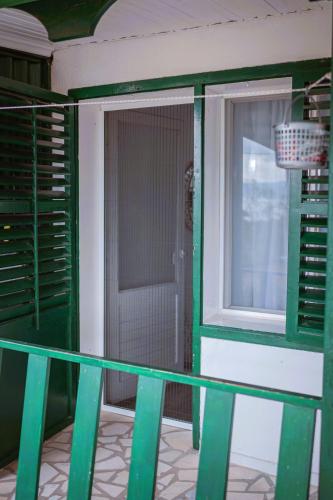 a balcony with a door and a window at Odisea House in Ljubaništa