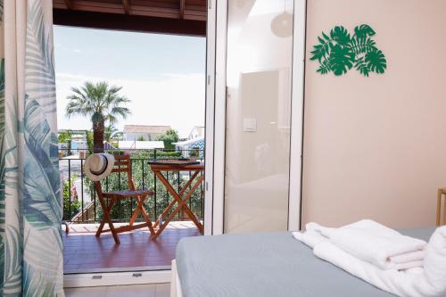 a room with a view of a balcony with a bed at Iris Apartments in Glyfada