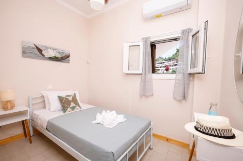 a small bedroom with a bed and a window at Iris Apartments in Glyfada