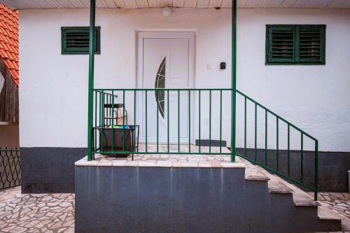 a stairway leading to a white house with a door at Odisea House in Ljubaništa