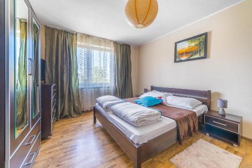 a bedroom with a bed and a large window at SŁONECZNIK in Ostrowo