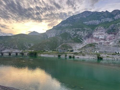 a view of a river with mountains in the background at Breeze of the Drin Guesthouse Camping in Vau i Dejës