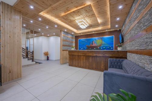 a lobby with a large screen in a building at The Ravasa in Manāli