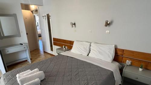 a bedroom with a bed with two towels on it at Villa Konstantina in Tolo