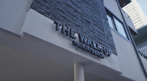 a sign on the side of a building at The Walk-Up Waikiki Beach in Honolulu