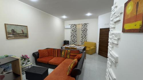 a living room with a couch and a yellow chair at Villa Franca on sea in Mazara del Vallo