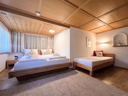 a bedroom with two beds and a window at D`Alpenapartments Bezau in Bezau