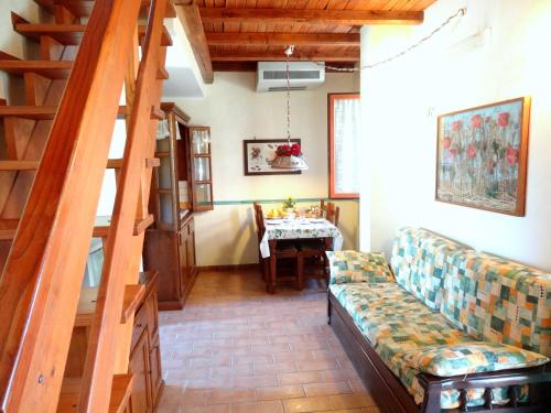 a living room with a couch and a staircase at Valle degli Arci in Castel Madama