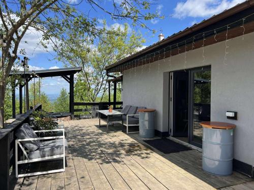 a patio with a table and chairs next to a building at The Hygge House in Plopi