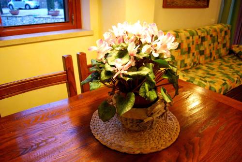 a vase filled with flowers on a wooden table at Valle degli Arci in Castel Madama