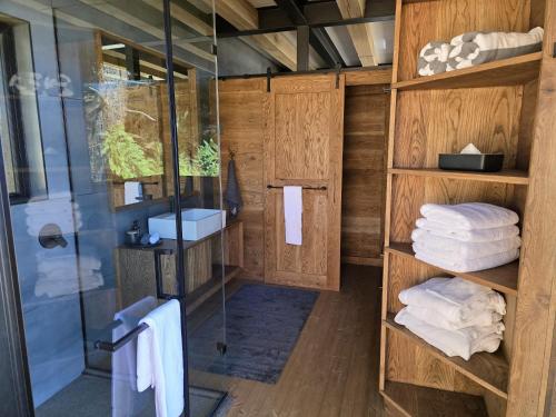 a bathroom with a shower and some towels at Eagle View on Beumont in Dullstroom
