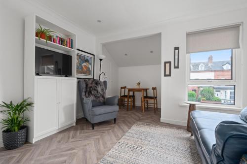 a living room with a couch and a chair at Belmont Apartment in Belfast