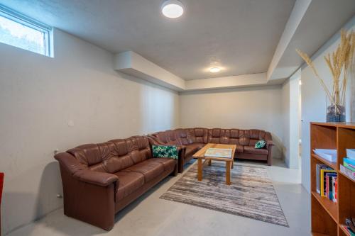 a living room with a couch and a table at Skogar Hostel in Skogar