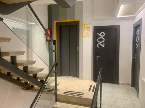 a hallway with a door and stairs in a building at Hotel DL Urban in Castellón de la Plana