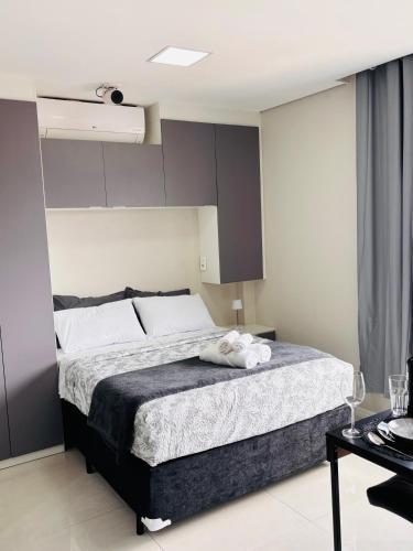 a bedroom with a bed with two towels on it at Studio Home 64 Luxo in Mogi das Cruzes