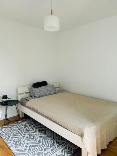 a bed in a room with a white wall at Deluxe in Burladingen
