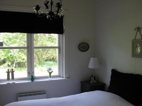 a bedroom with a bed and a window at Nice Home In Nykøbing Sjælland W in Nykøbing Sjælland
