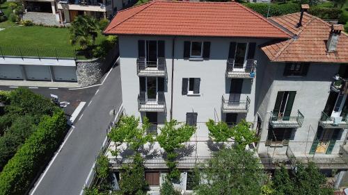 an overhead view of a white building with a red roof at Vista Lago Como in Ossuccio