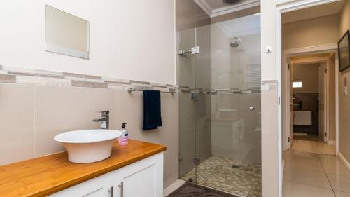a bathroom with a sink and a shower at 147 Abalone-Inn in Hermanus
