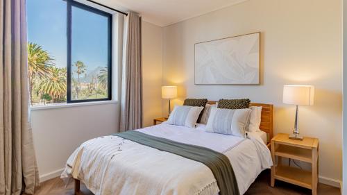 a bedroom with a large bed with a large window at Table Mountain View Apartment in Cape Town