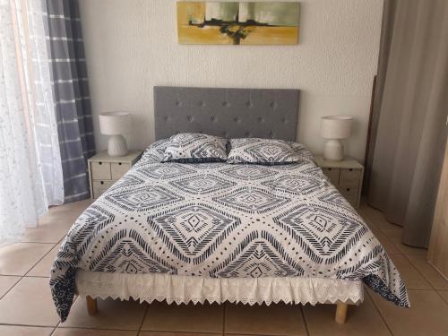 - une chambre avec un lit doté d'une couette et de 2 lampes dans l'établissement Studio à Sanary-Sur-Mer avec balcon à 200m du port, à Sanary-sur-Mer