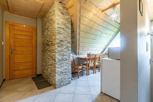 a kitchen and dining room with a brick wall at Willa Tatra House in Zakopane