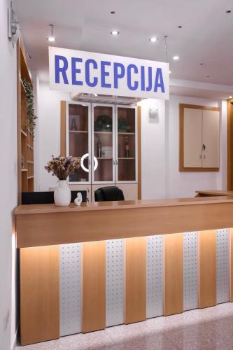 a reception desk in a store with a sign at Villa Lasić Neum in Neum