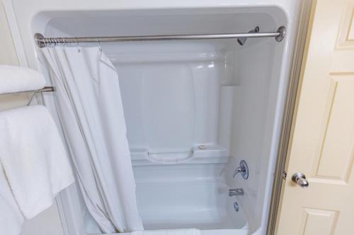 ein Badezimmer mit Dusche und weißem Duschvorhang in der Unterkunft Gordon Hall Residence in Guelph