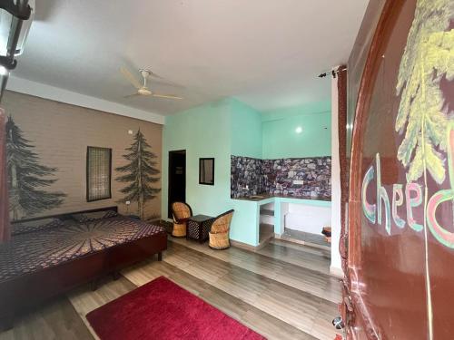 a bedroom with a bed and a desk in a room at Utsav riverbank homestay in Haldwāni