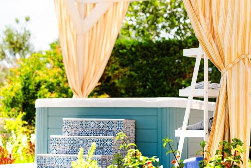 a set of three blue and white stairs with curtains at Memories Apartments in Laganas