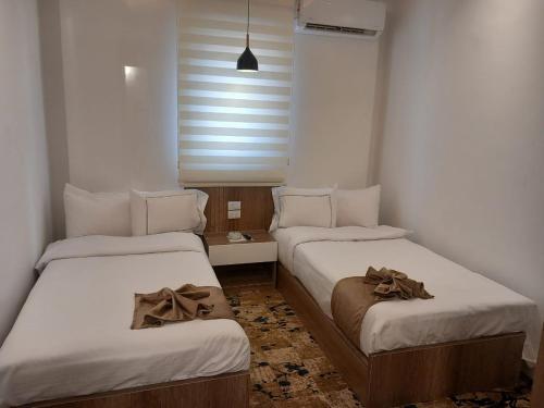 a room with two beds with bows on them at فندق الحسين السياحي in Asyut