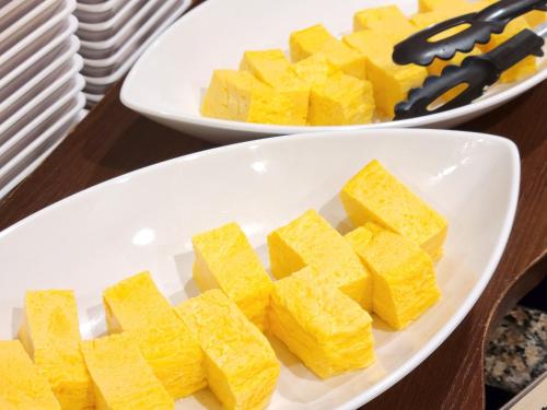 two plates of cheese sticks on a table at Smile Hotel Osaka Tennoji in Osaka