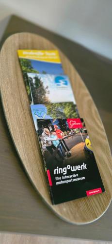 a magazine sitting on top of a wooden table at RINGZEIT-Lodge in Herresbach