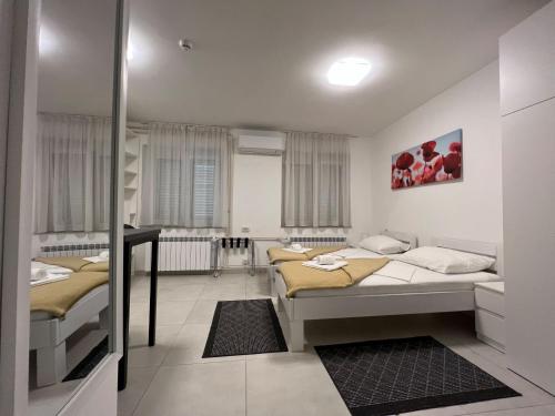 a bedroom with two beds in a room at Rijeka Budget Rooms in Rijeka
