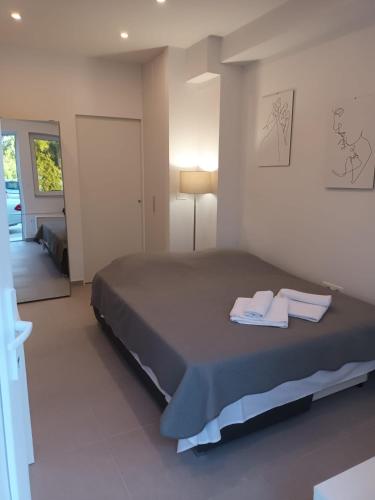 a bedroom with a bed with two towels on it at Beach studio KATE - Wake up to the sea, terrace, garden & parking, Murter - Dalmatia in Murter