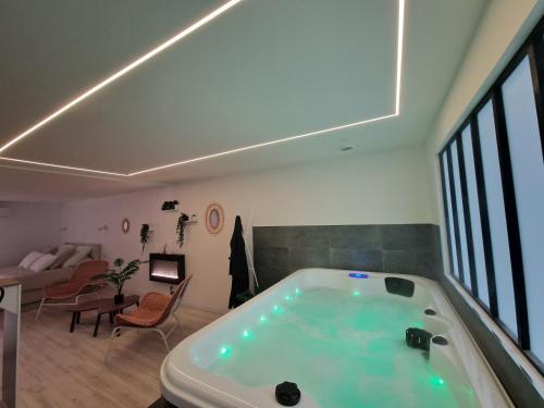 d'un salon avec une grande baignoire et un canapé. dans l'établissement la chambre 8, à Saint-Martin-du-Var