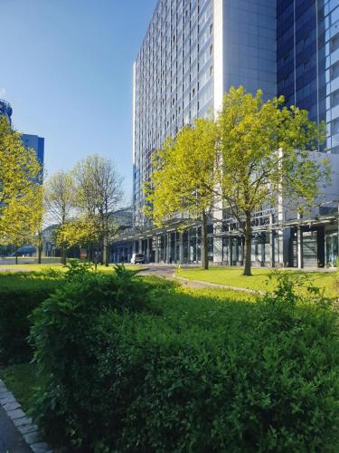 a park in front of a tall building at Apartment In SI-Centrum in Stuttgart
