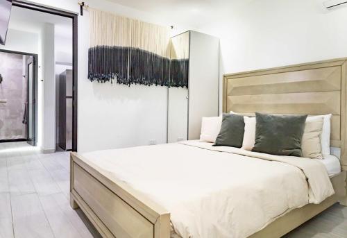 a white bedroom with a large bed in it at Renovated 3 BR House in Dorado del Mar in Dorado