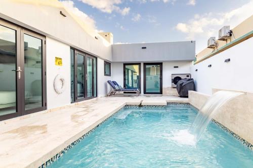 a swimming pool in the backyard of a house at Renovated 3 BR House in Dorado del Mar in Dorado