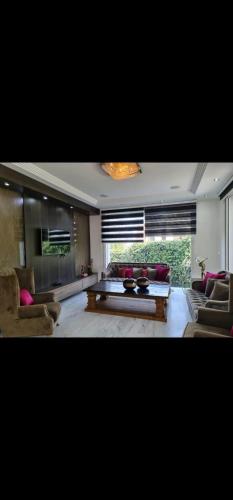 a living room with couches and a coffee table at Villa Magnifique M9 in Tunis